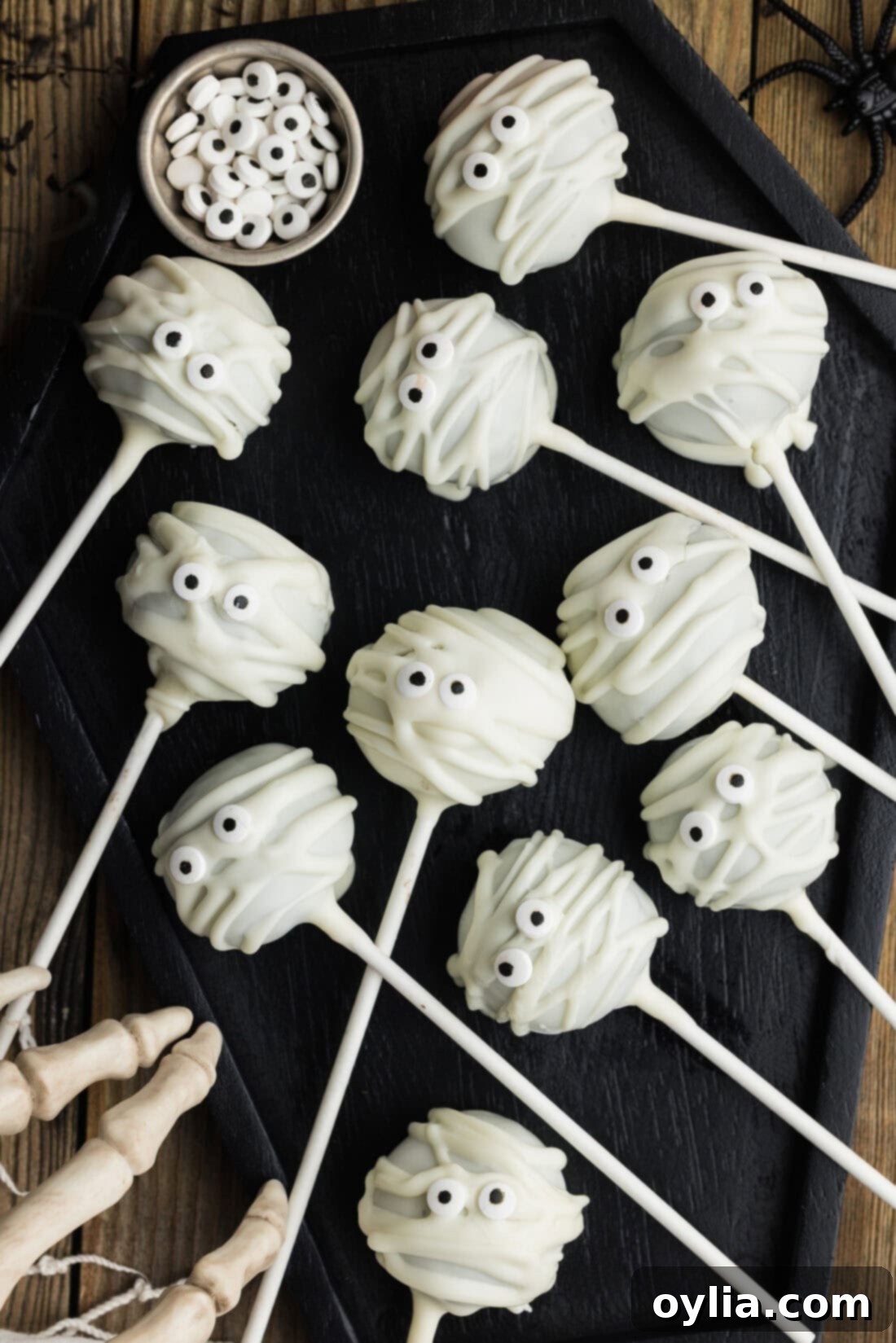 Close up photo of Mummy Pops arranged neatly in a black tray, showcasing their detailed decoration