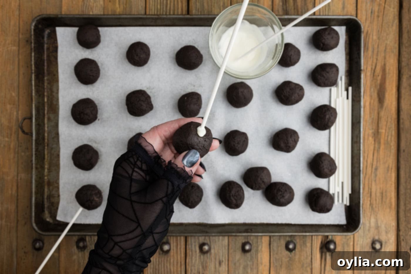 A lollipop stick inserted into the bottom of an Oreo truffle ball, secured with a dab of melted chocolate