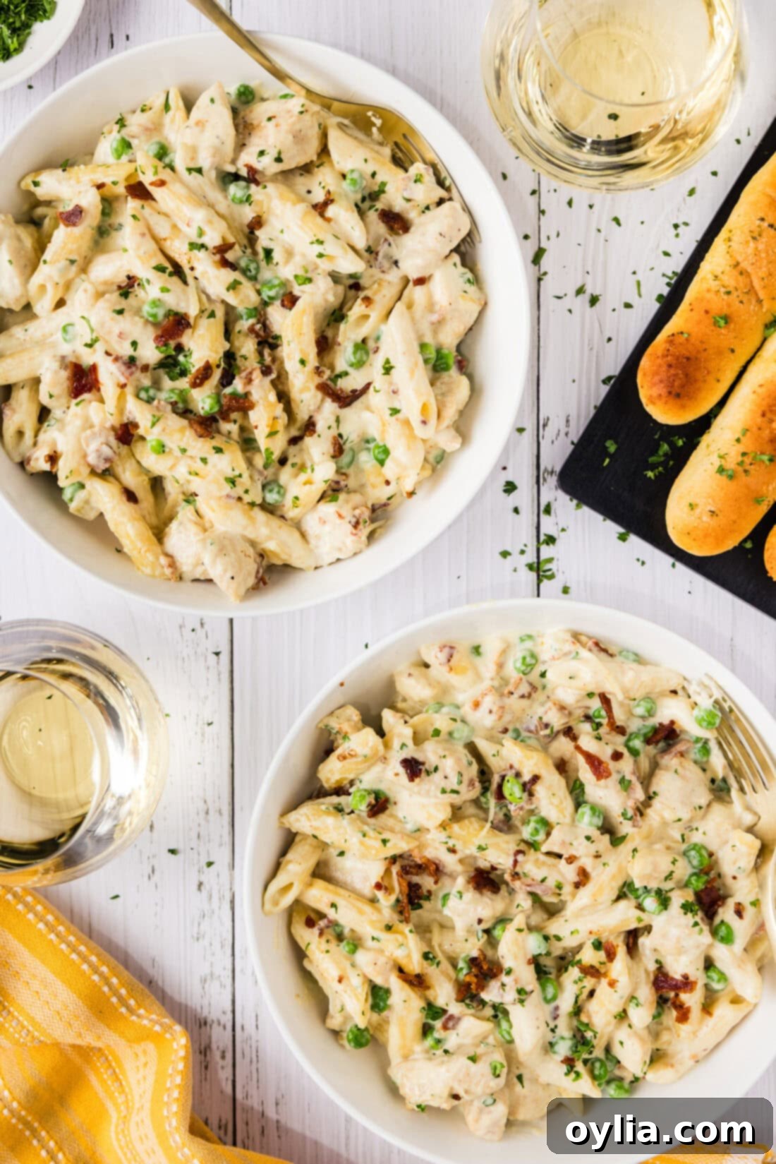 Two bowls of Chicken Carbonara, garnished and ready to serve