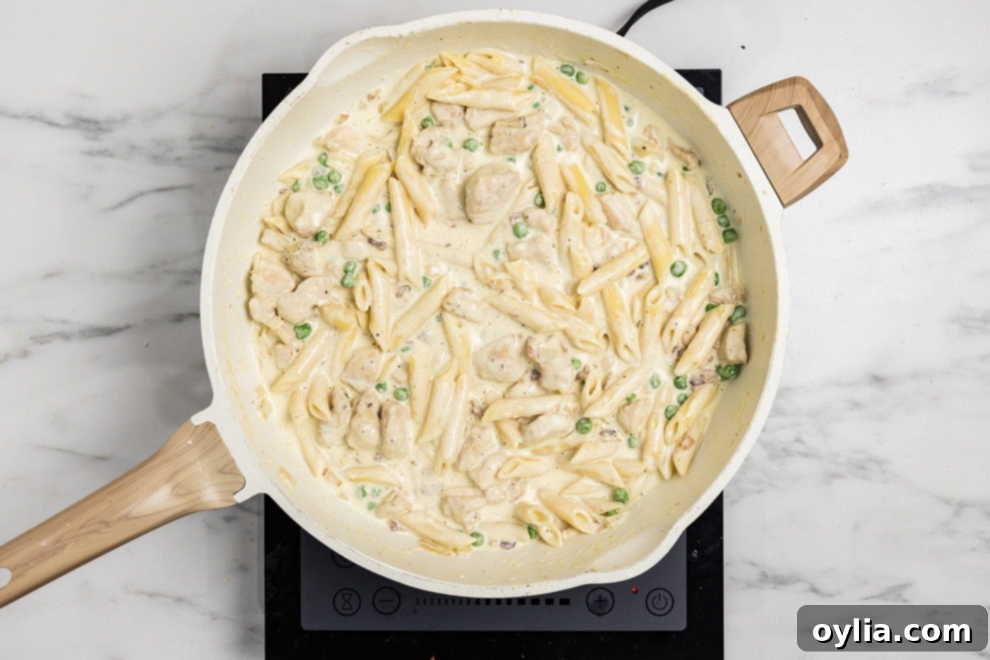 overhead photo of finished creamy chicken carbonara in a skillet, ready to be served