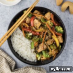 Bowl of Tofu Stir Fry with chopsticks on the side