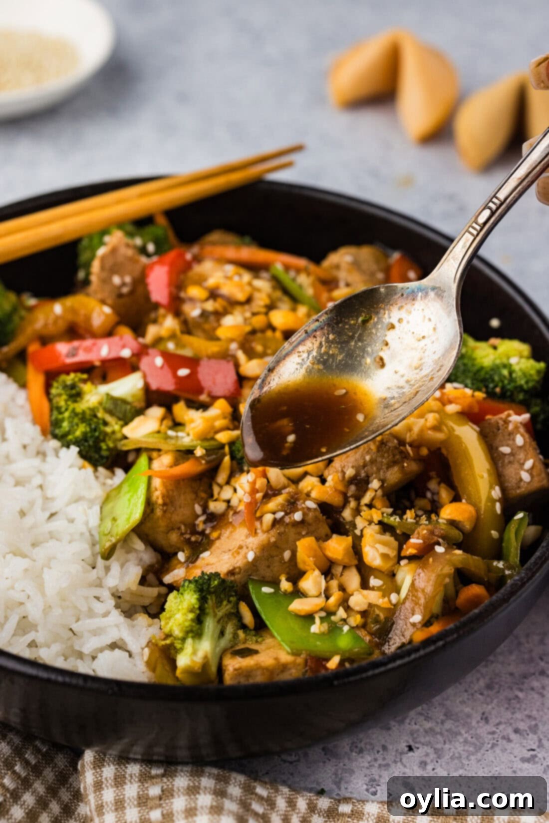 Flavorful Tofu Stir-Fry 10 Spoon drizzling sauce over Tofu Stir Fry