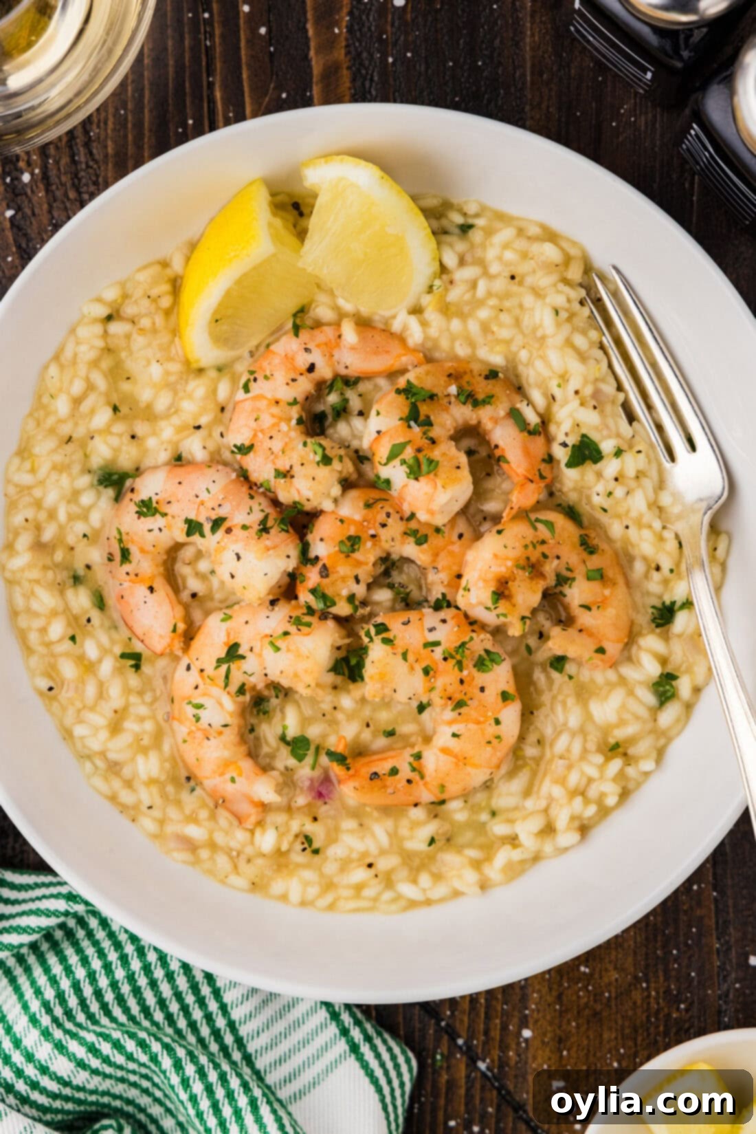 A beautifully presented bowl of creamy shrimp risotto with a fork ready to enjoy, highlighting the plump shrimp and rich rice.