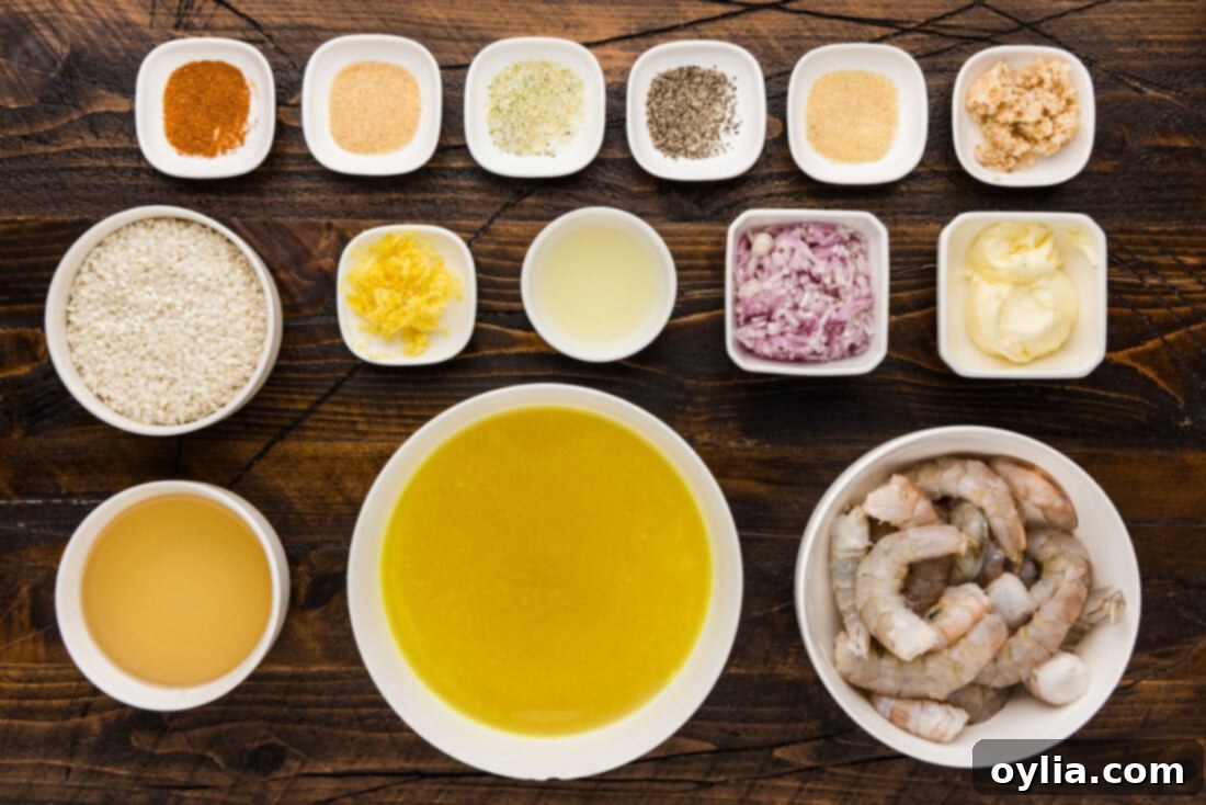 A collection of fresh ingredients laid out, including raw shrimp, Arborio rice, lemons, butter, shallots, garlic, and seasonings, ready for making shrimp risotto.