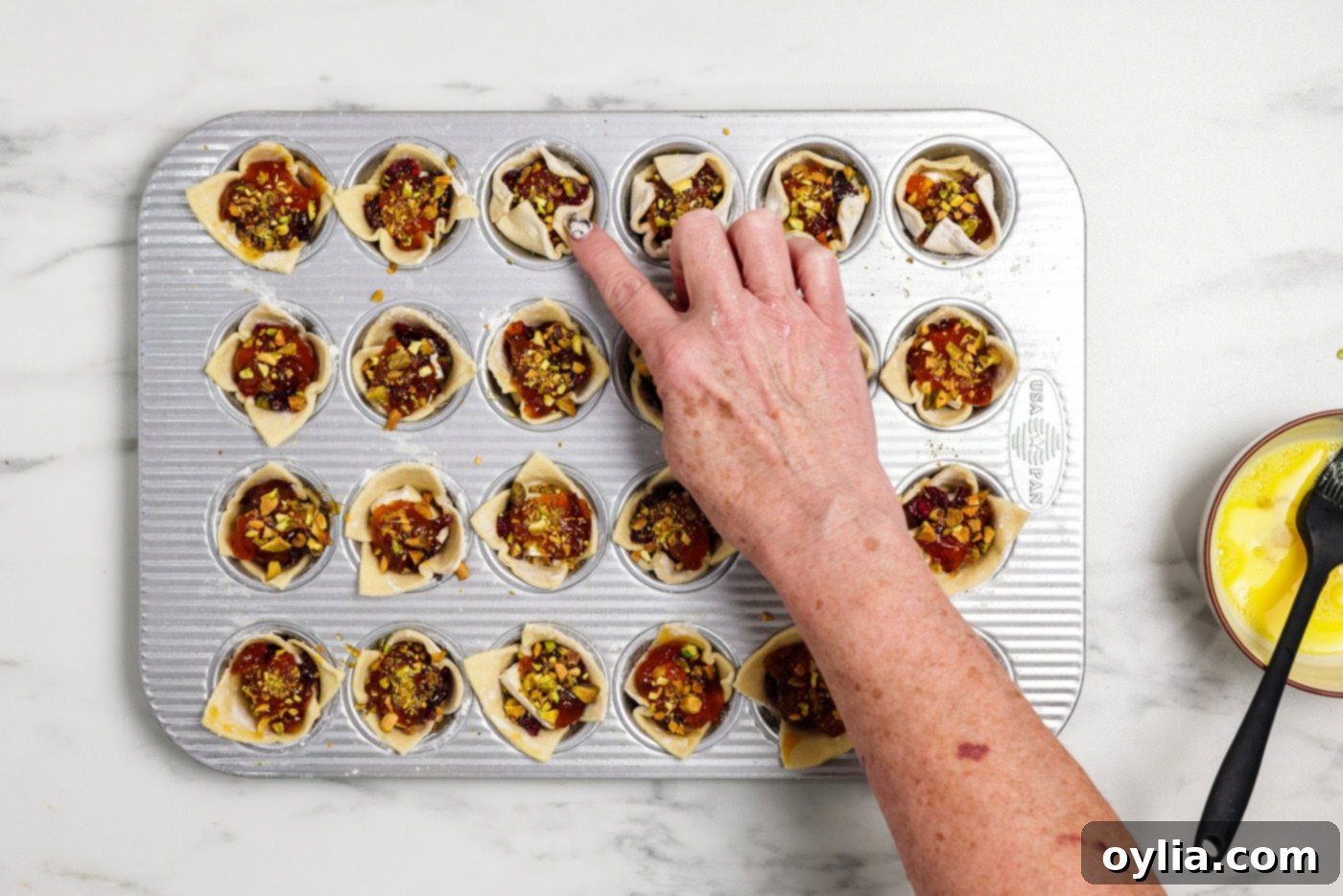finger gently pressing sides of puff pastry inwards