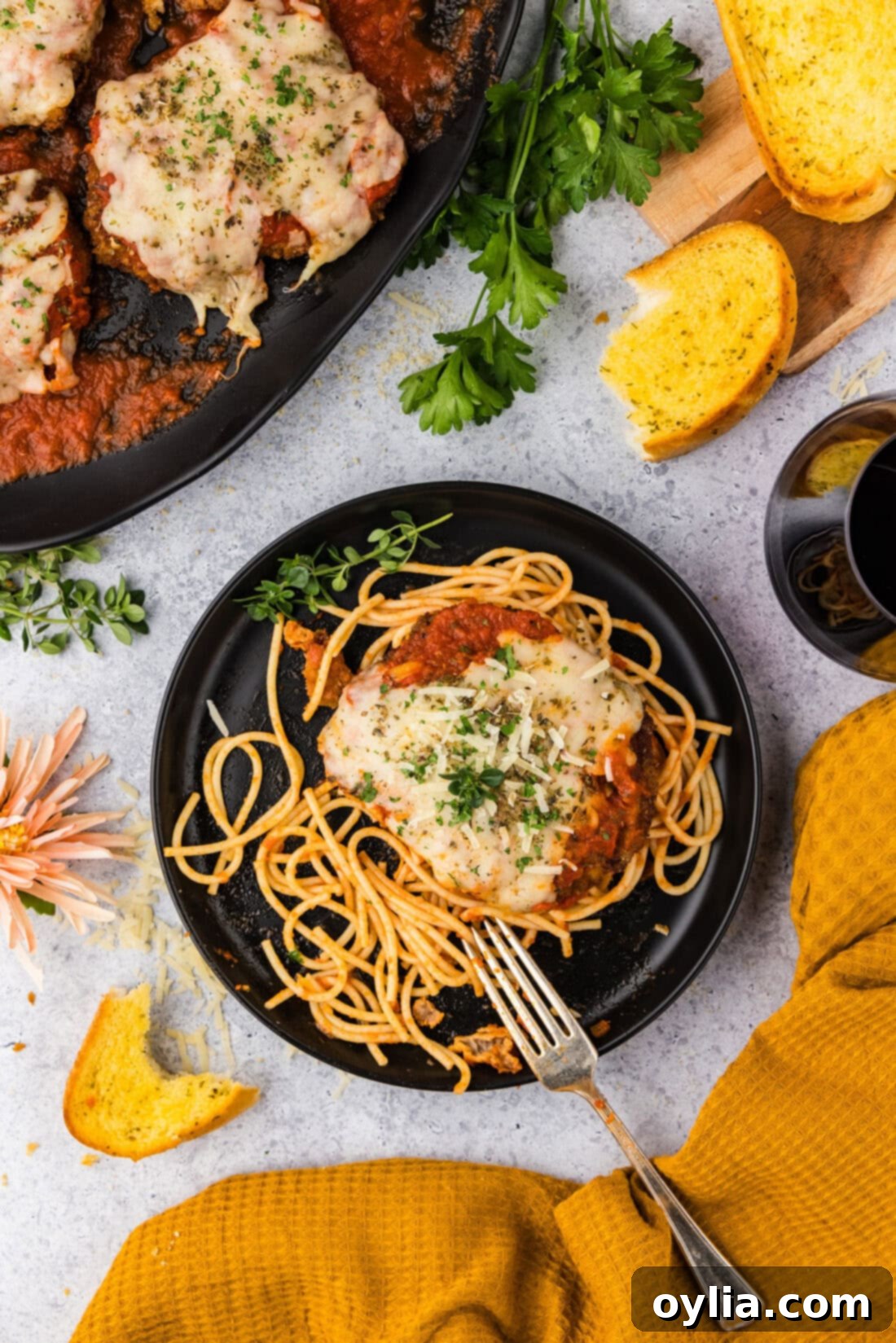 Plate of Veal Parmesan with garlic bread to the side