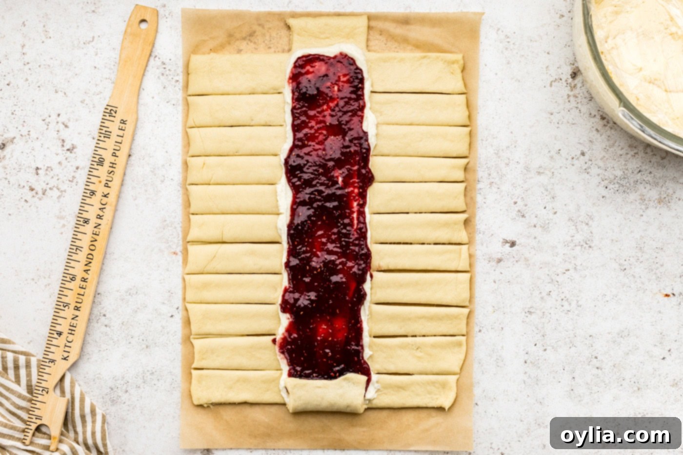 Strips cut out on sides of dough along the filling lines