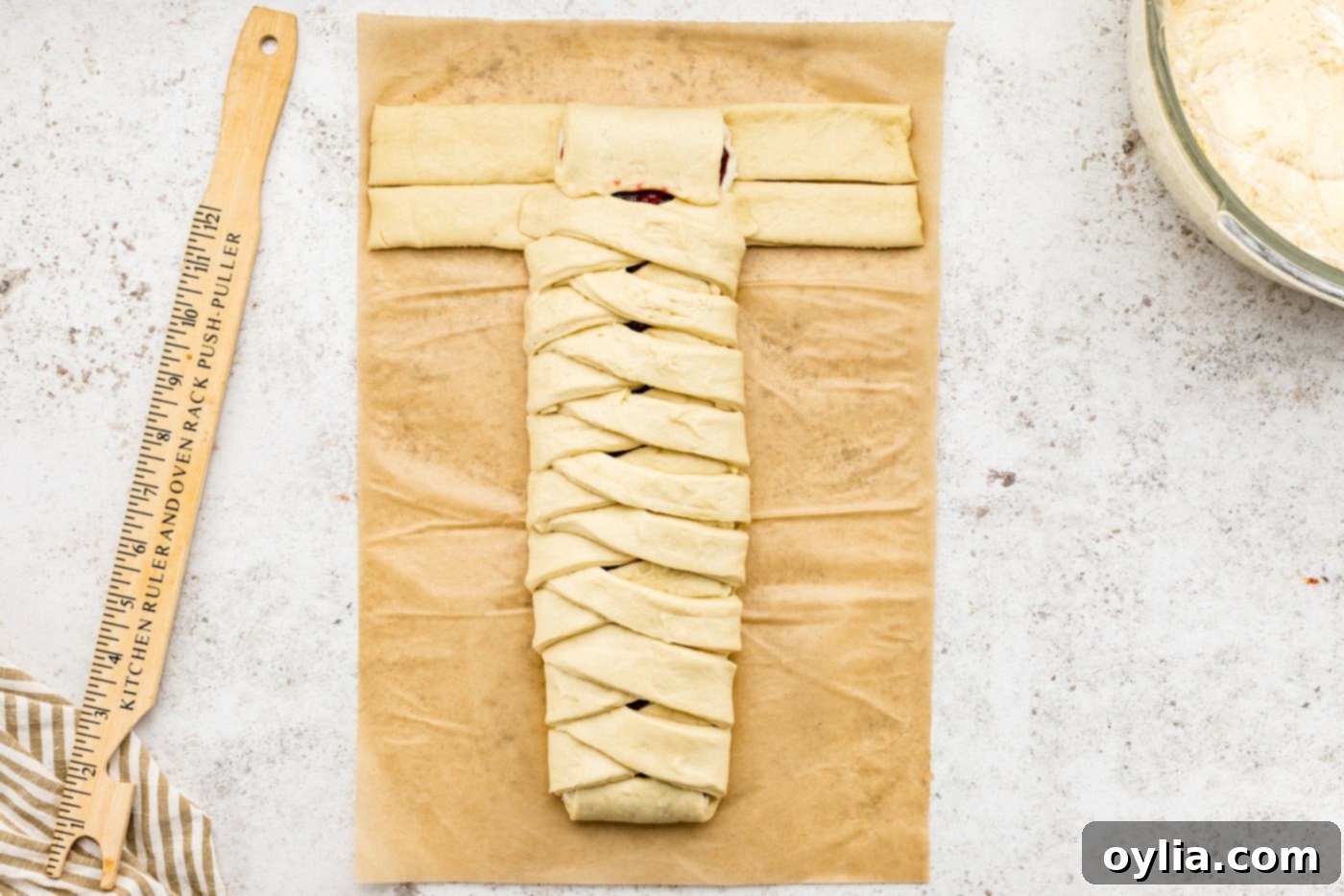 Folding the end tab of the sectioned dough over the filling