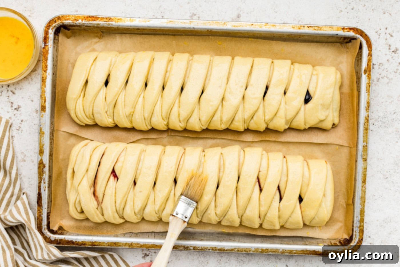 Brushing danish dough with egg wash