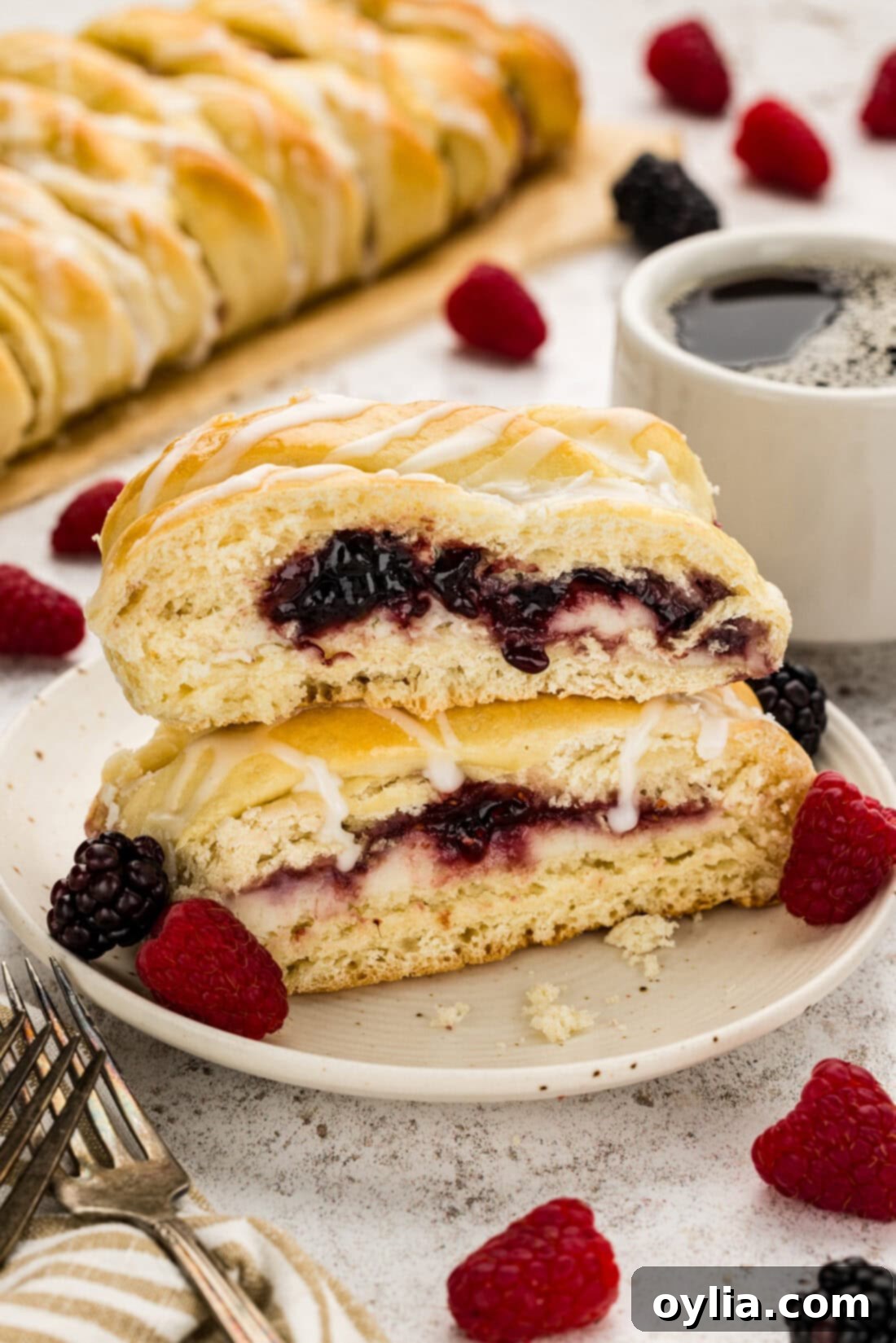 Two slices of Braided Breakfast Danish stacked on a plate