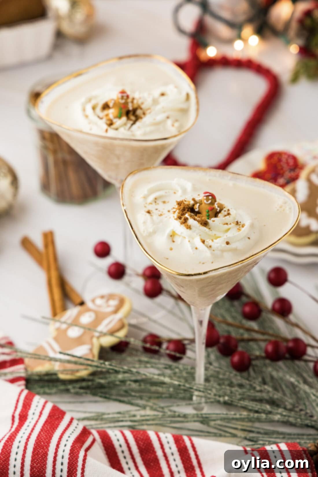 Two Gingerbread Martinis surrounded by gingerbread cookies