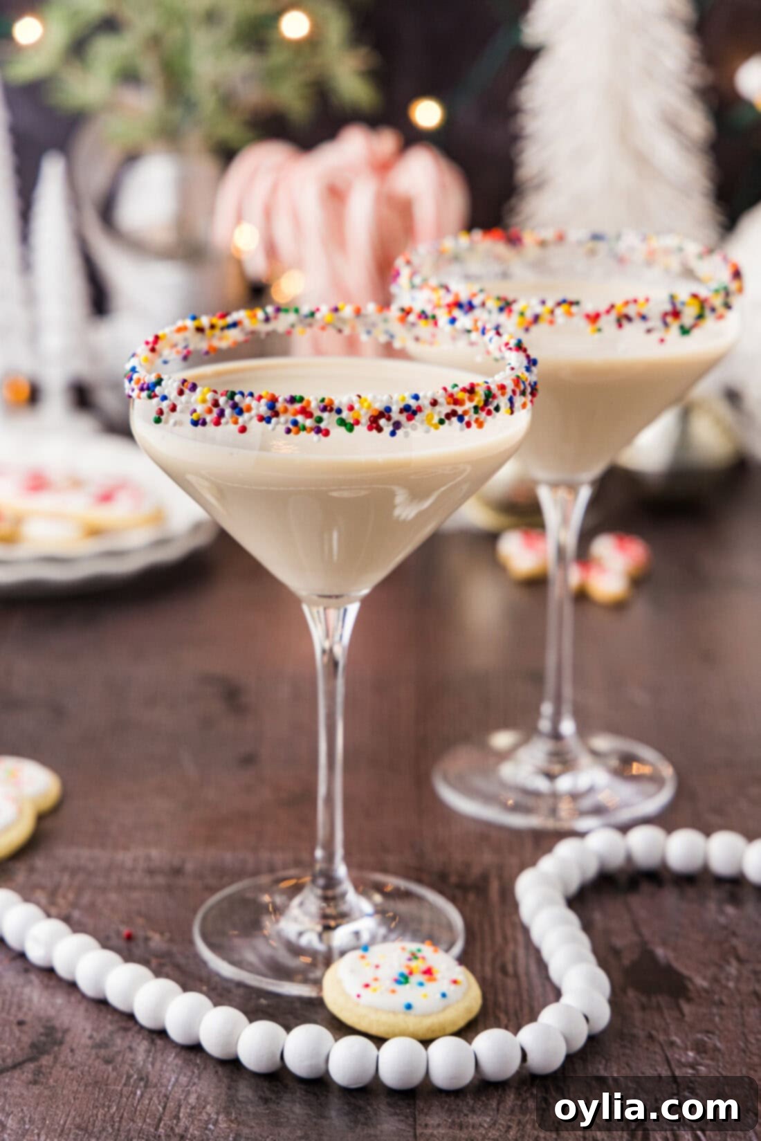 Two Sugar Cookie Martinis surrounded by holiday decorations