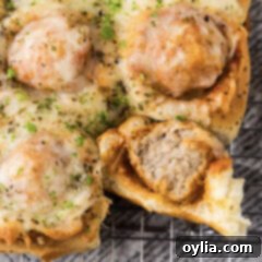 Close up photo of a Meatball Slider with a bite taken out of it