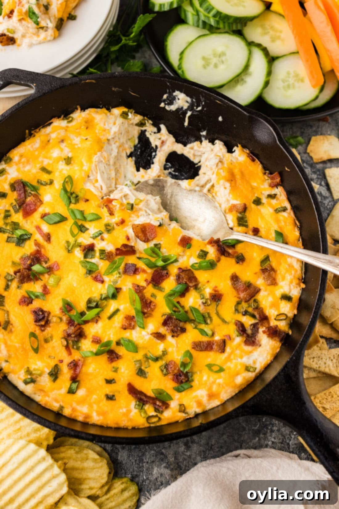 Spoon scooping Chicken Bacon Ranch Dip from a skillet
