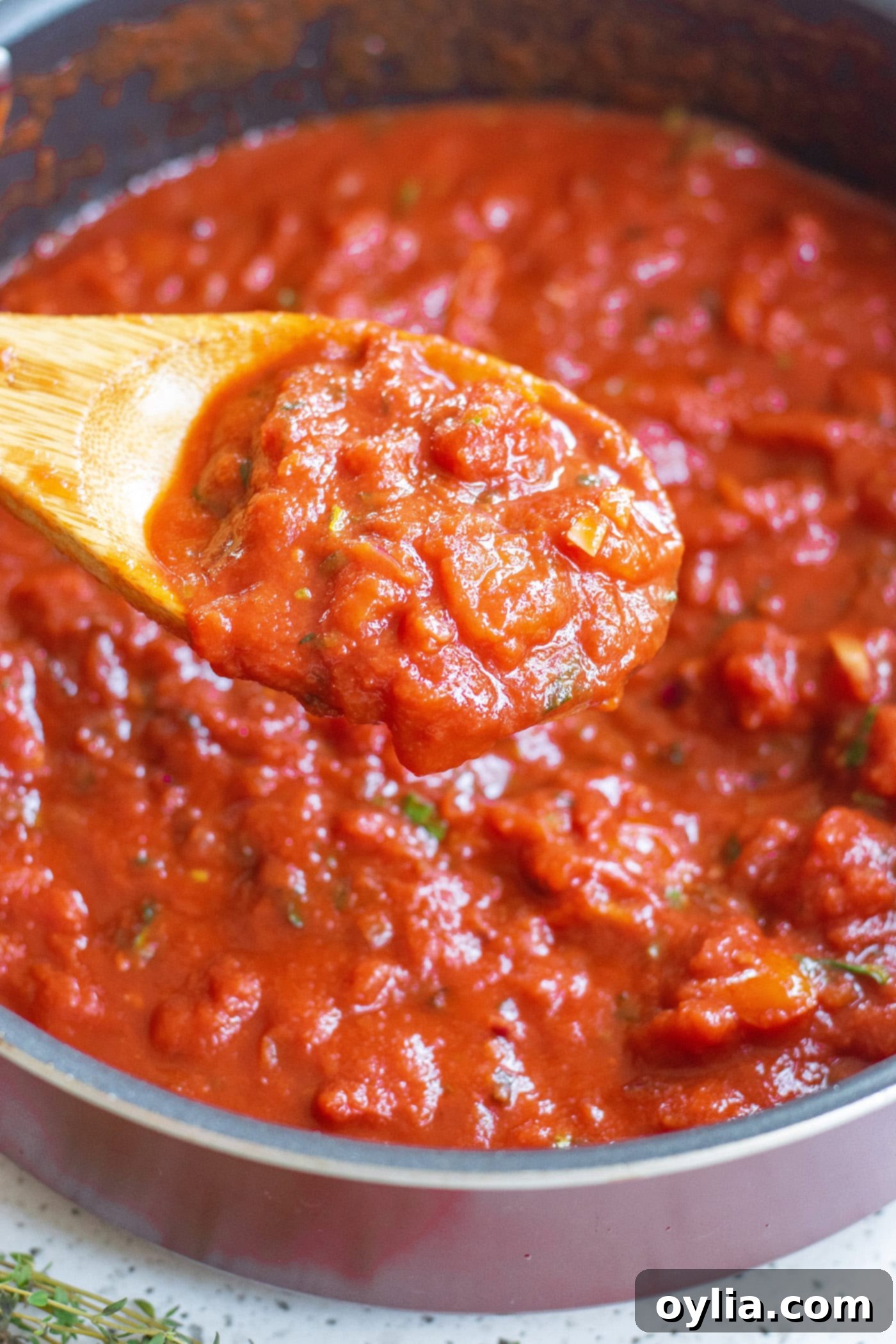 Homemade Marinara: A Taste of Italy 6 Wooden spoon stirring a pot of simmering marinara sauce