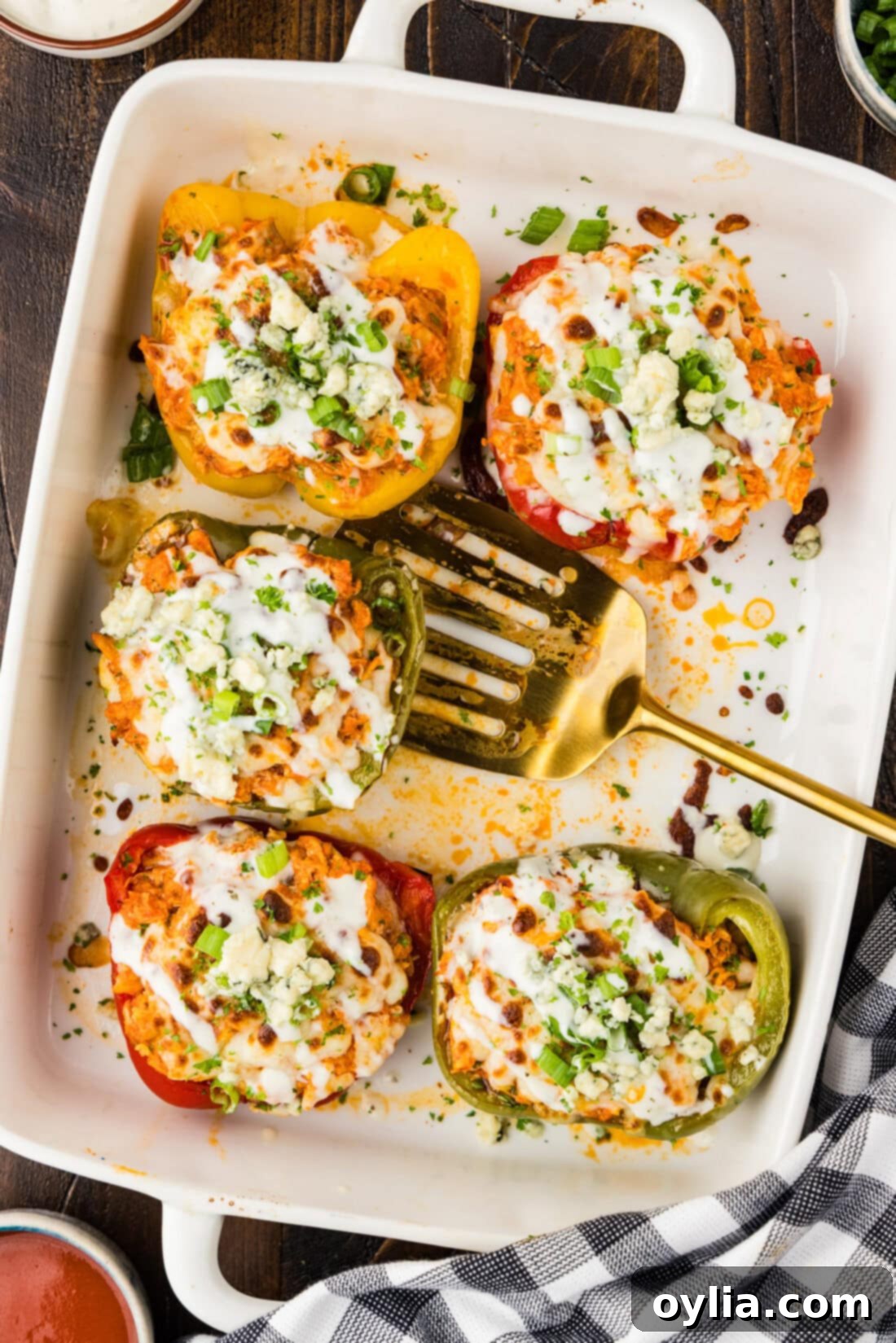 Buffalo Chicken Stuffed Bell Peppers 2 Five Buffalo Chicken Stuffed Peppers in a dish with a spatula