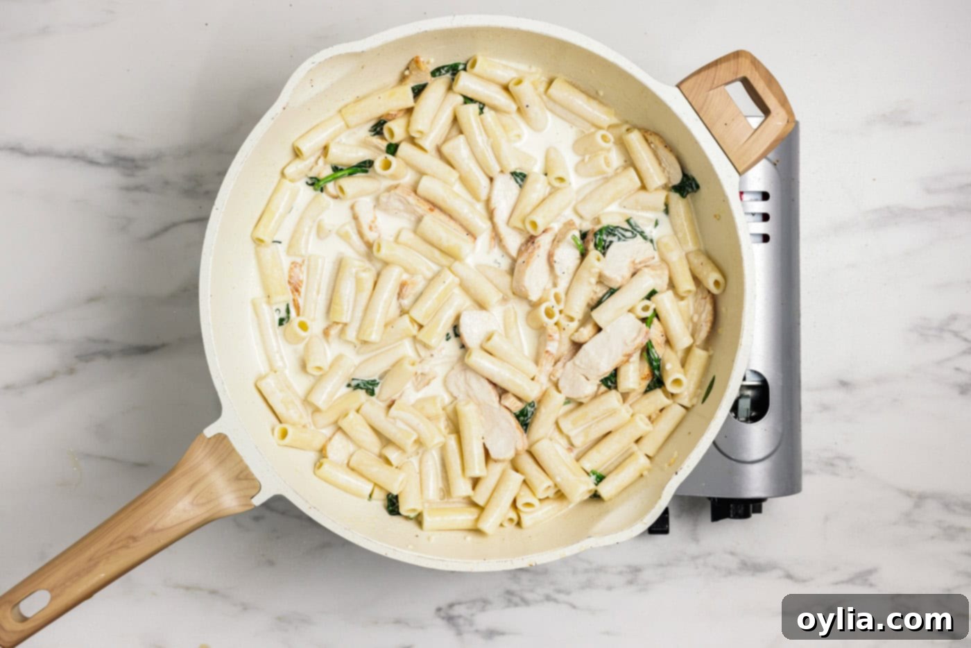 Creamy garlic chicken pasta in a skillet