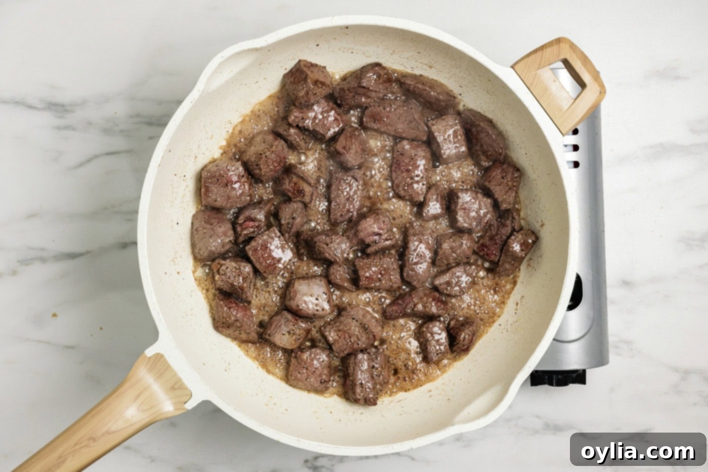 Sirloin cubes browned in a skillet